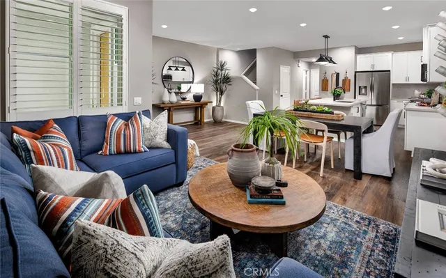 a living room with furniture and kitchen view