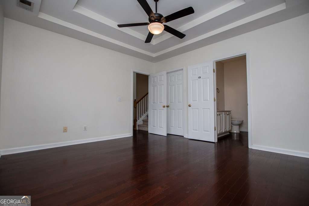 255 Morgan Road Carrollton, GA 30116 - Photo 25 of 57 an empty room with hard wood floors and a ceiling fan