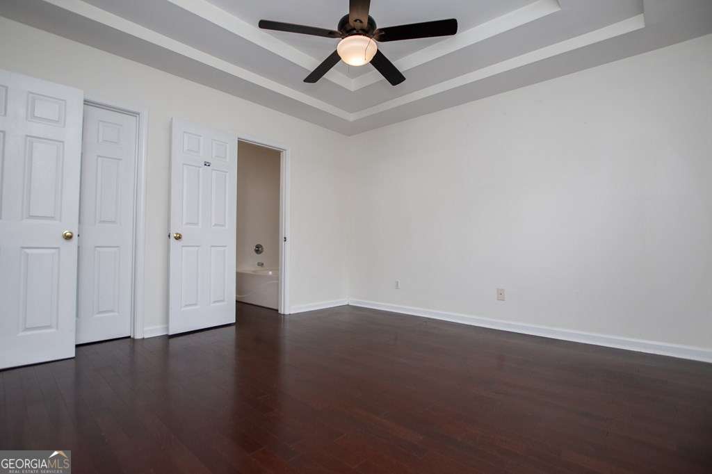 255 Morgan Road Carrollton, GA 30116 - Photo 26 of 57 an empty room with wooden floor a ceiling fan and closet