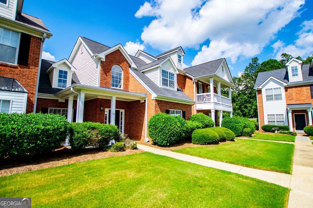 255 Morgan Road Carrollton, GA 30116 - Photo 3 of 57 a view of a brick building next to a yard