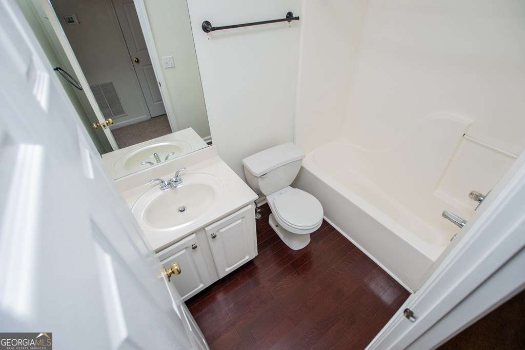 255 Morgan Road Carrollton, GA 30116 - Photo 40 of 57 a white toilet sitting next to a bathroom sink