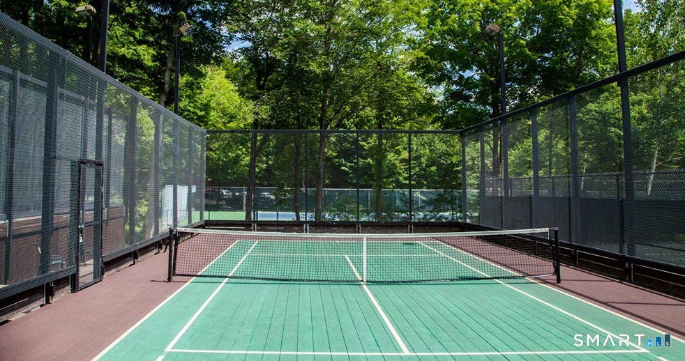 151 Old Farms, Unit 151 Torrington, CT 06790 - Photo 10 of 39 a view of a tennis court with lots of trees in the background