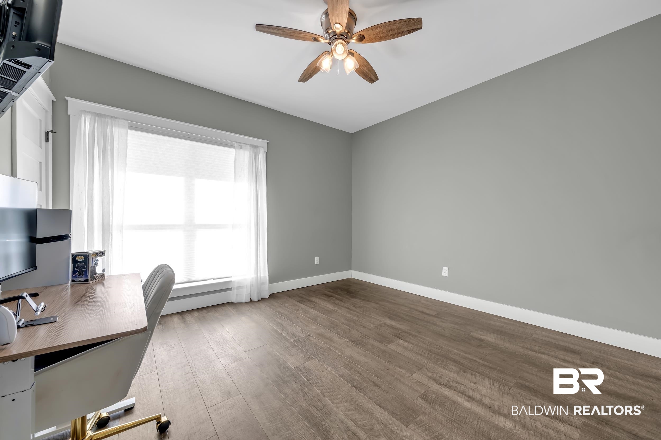 6576 Ranch Loop Road East Grand Bay, AL 36541 - Photo 22 of 39 Bright room featuring wood-finish flooring, a ceiling fan with light, and a large window with white trim