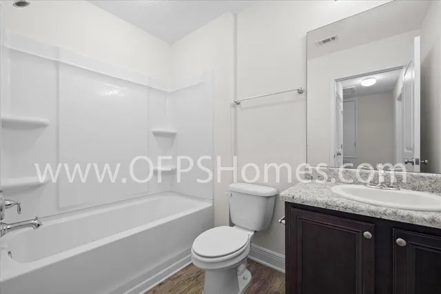 a bathroom with a sink a toilet and a bathtub