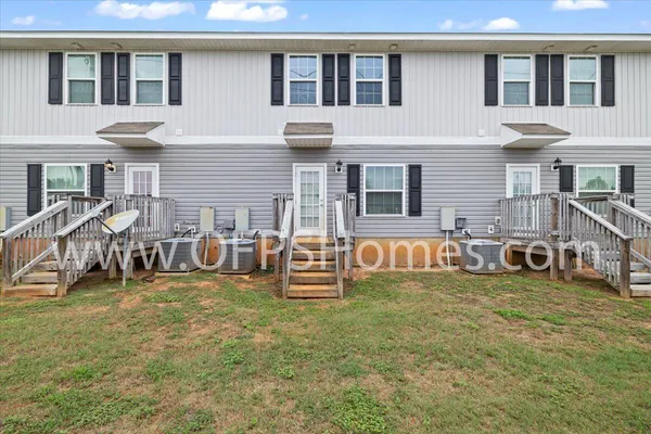a view of a house with a yard and sitting area