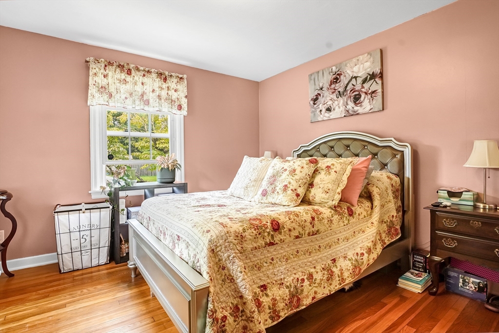 90 Roanoke Road Springfield, MA 01118 - Photo 11 of 19 a bedroom with a bed and wooden floor
