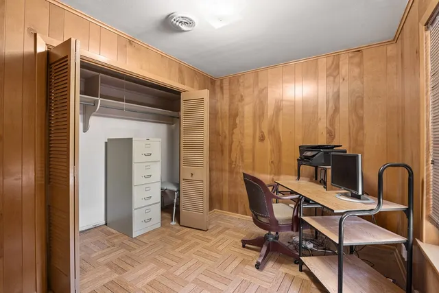 a view of a workspace with furniture and a window