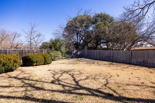 a view of wooden fence and trees around