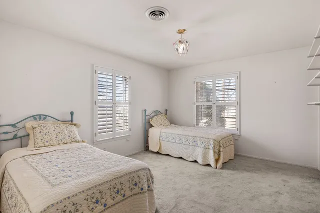 a bedroom with bed and a window