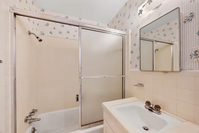 a bathroom with a shower and a sink