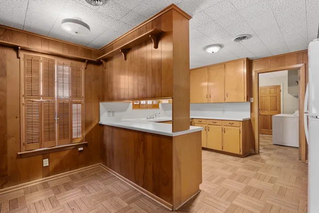 a spacious bathroom with a granite countertop sink mirror and a bathtub