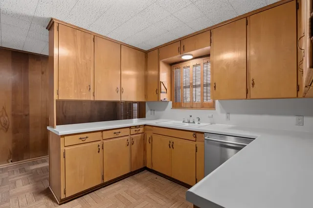 a kitchen with a sink cabinets and window