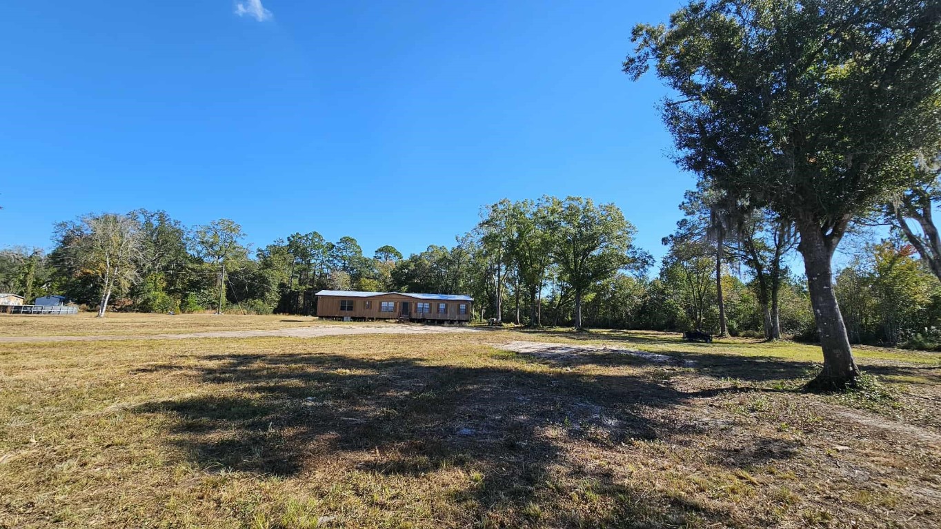 17539 Hodges Road Hilliard, FL 32046 - Photo 14 of 62 a big yard with trees in the background