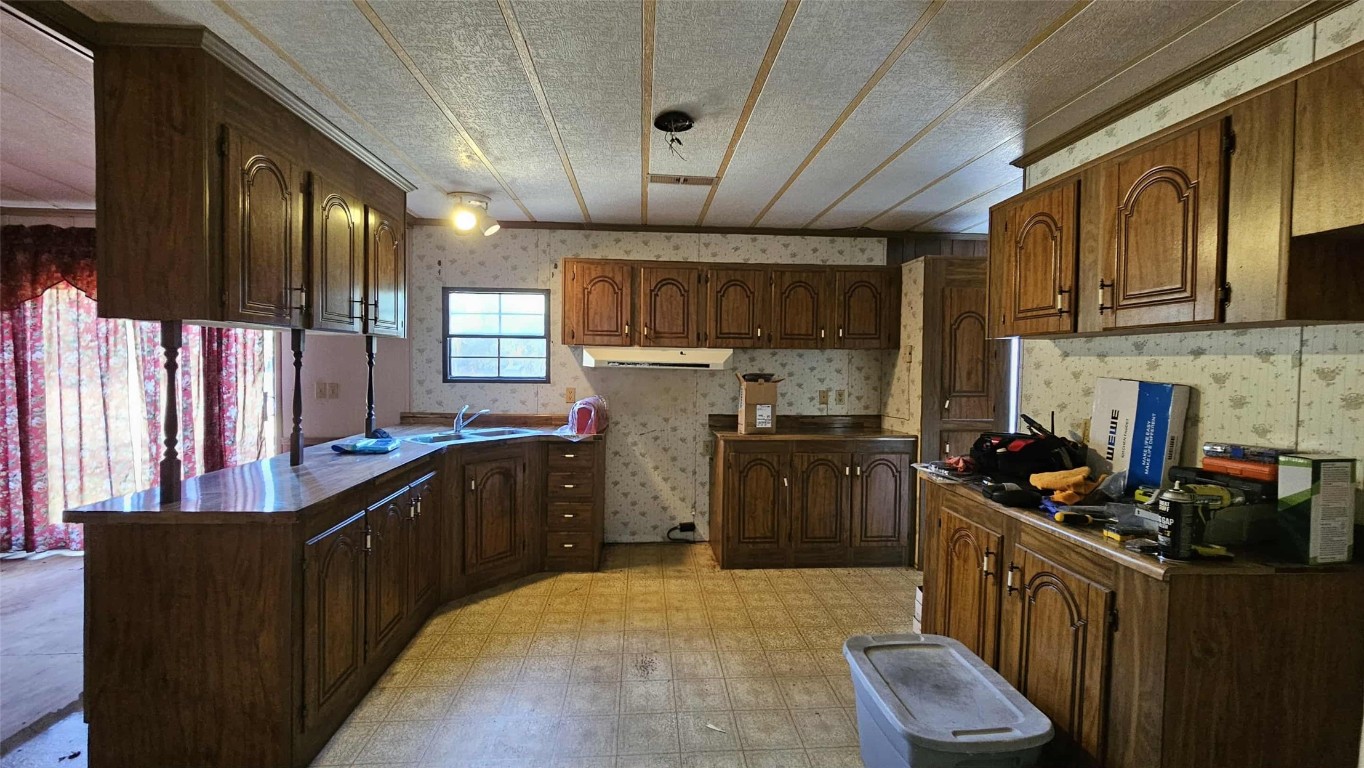 17539 Hodges Road Hilliard, FL 32046 - Photo 39 of 62 a kitchen with lots of counter top space a sink and stainless steel appliances