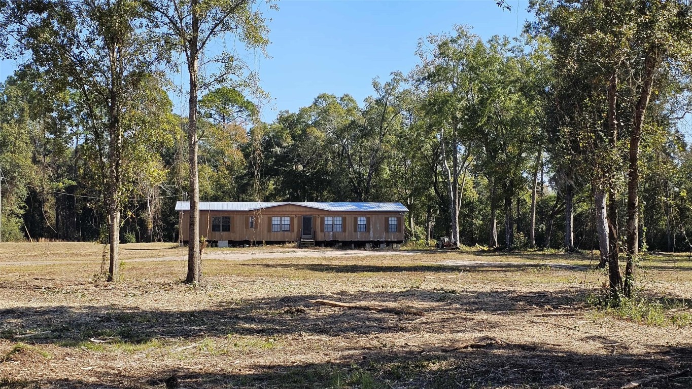 17539 Hodges Road Hilliard, FL 32046 - Photo 49 of 62 a view of a house with trees and yard