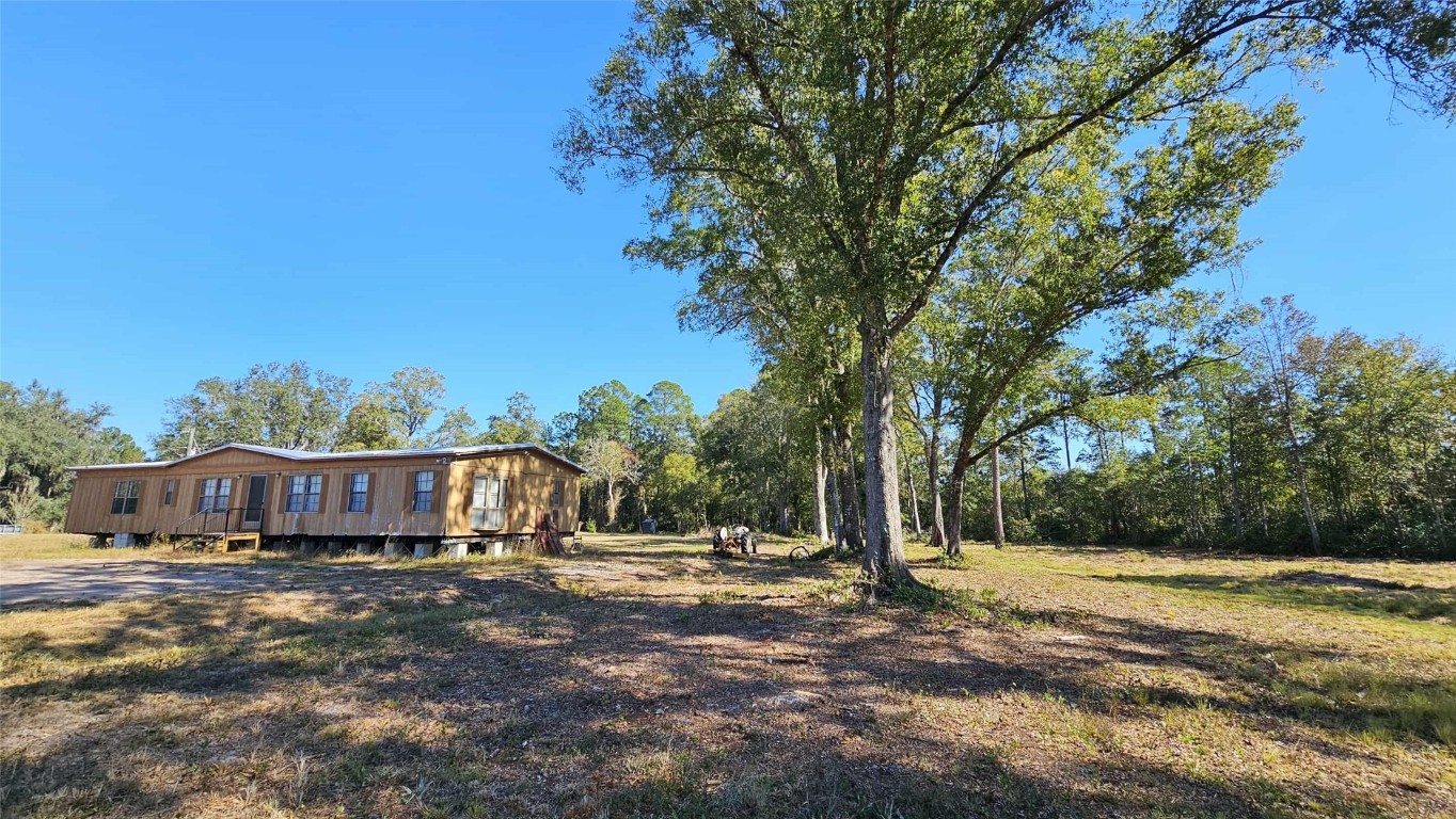 17539 Hodges Road Hilliard, FL 32046 - Photo 54 of 62 a view of house with yard and tree in the background