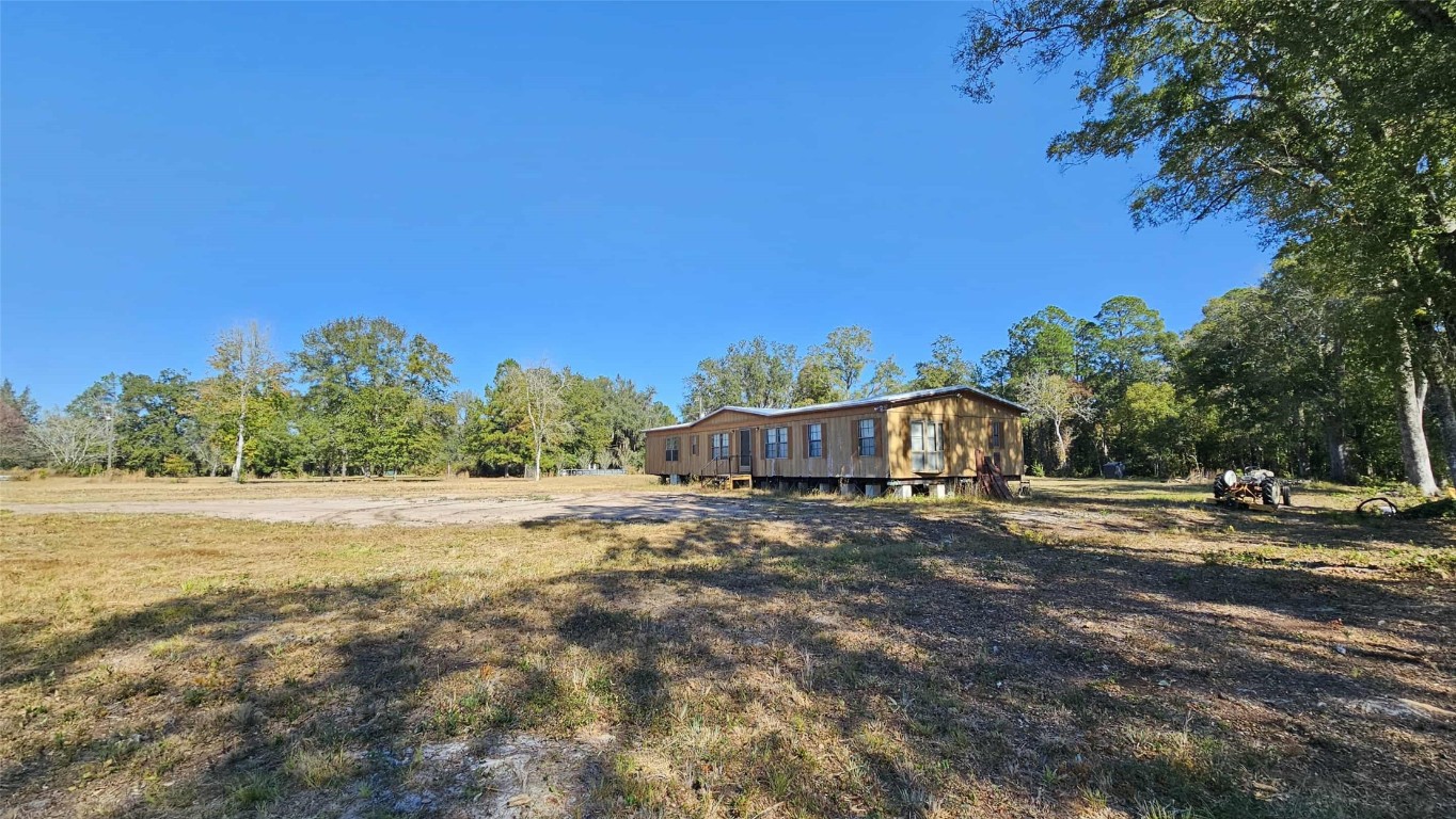 17539 Hodges Road Hilliard, FL 32046 - Photo 59 of 62 a view of an house with backyard and a tree