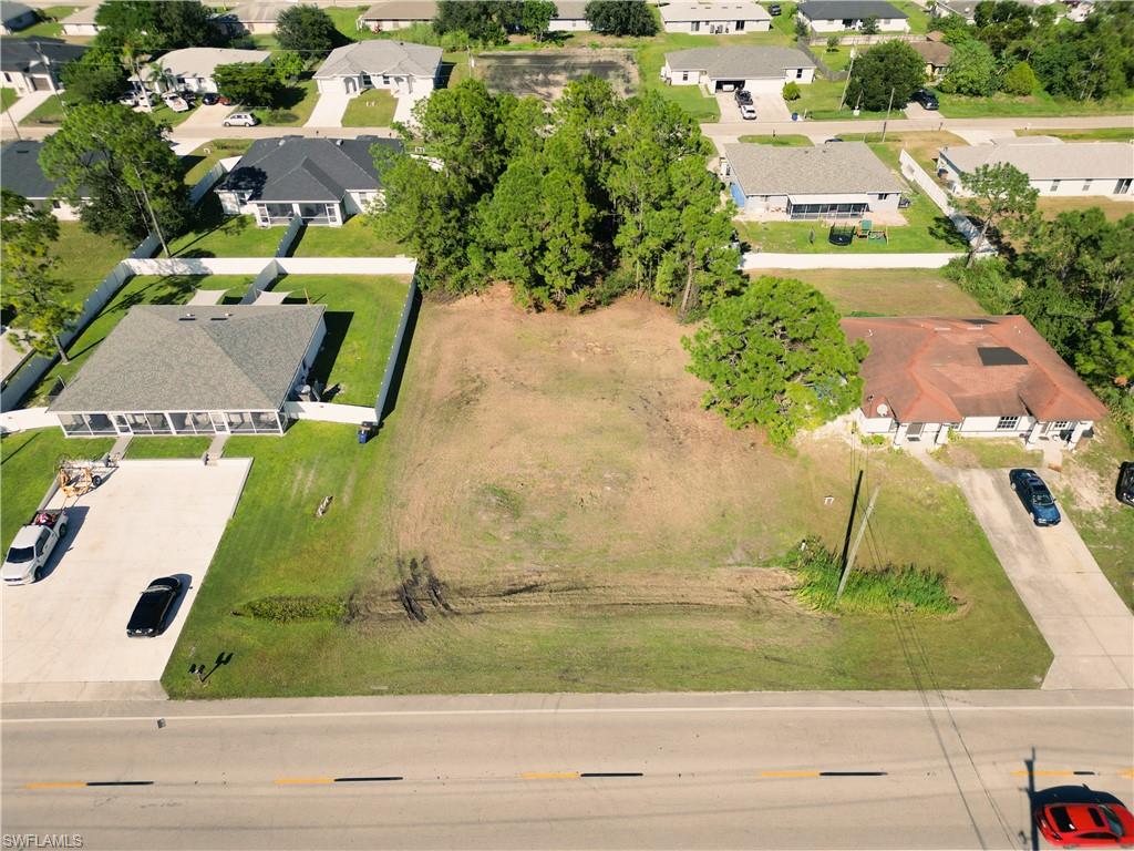 4528 Leonard Boulevard South Lehigh Acres, FL 33973 - Photo 9 of 10 an aerial view of a house with a yard and lake view