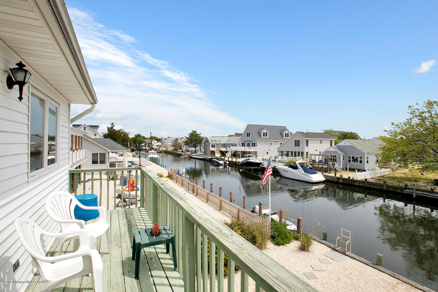 722 Drum Point Road Brick, NJ 08723 - Photo 22 of 28 a view of a lake with boats and trees in front of house