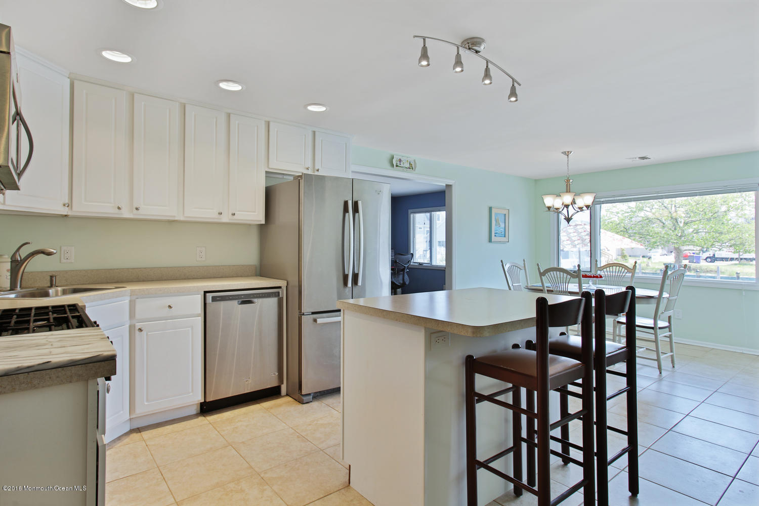 722 Drum Point Road Brick, NJ 08723 - Photo 5 of 28 a kitchen with refrigerator cabinets dining table and chairs