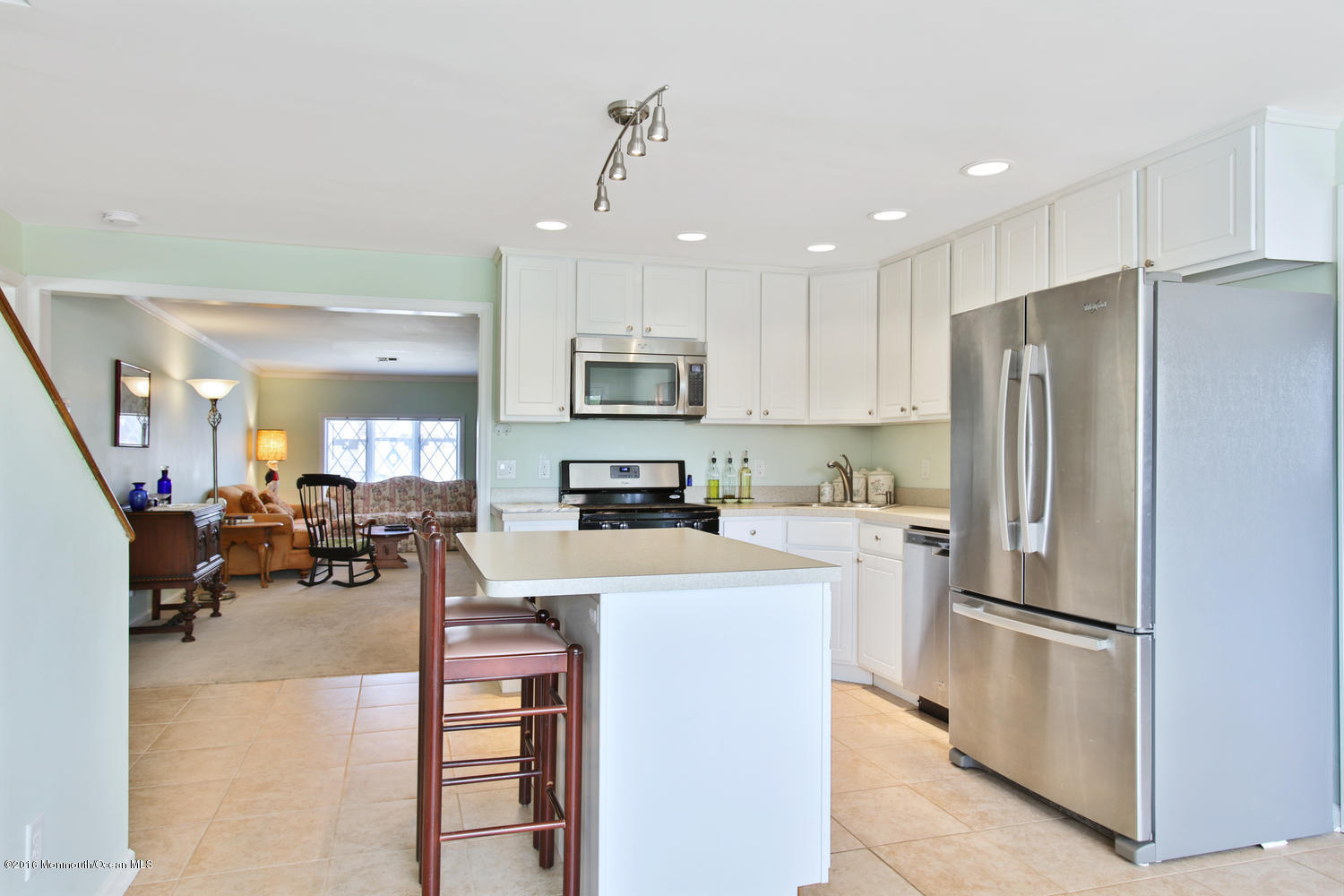 722 Drum Point Road Brick, NJ 08723 - Photo 6 of 28 a kitchen with refrigerator a sink and chairs