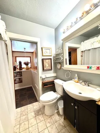 a bathroom with a sink toilet and mirror