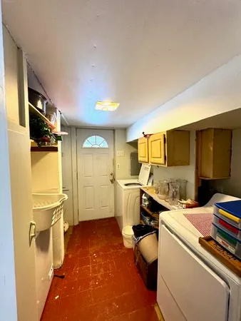 a room with a chair and appliances