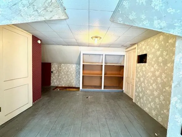 a view of an empty room with a fireplace