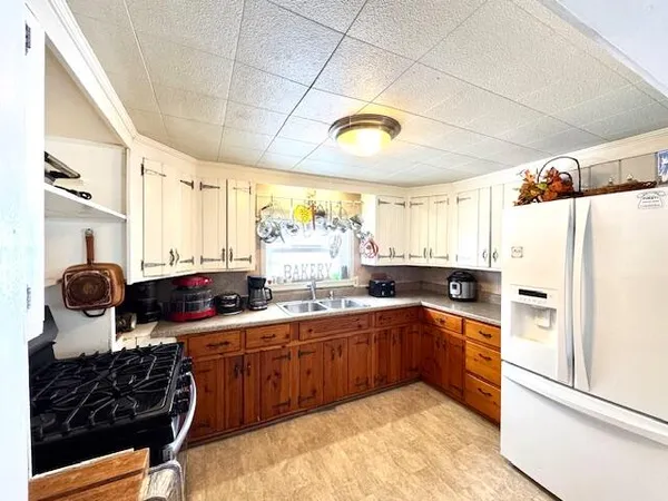 a kitchen with stainless steel appliances a sink stove and refrigerator