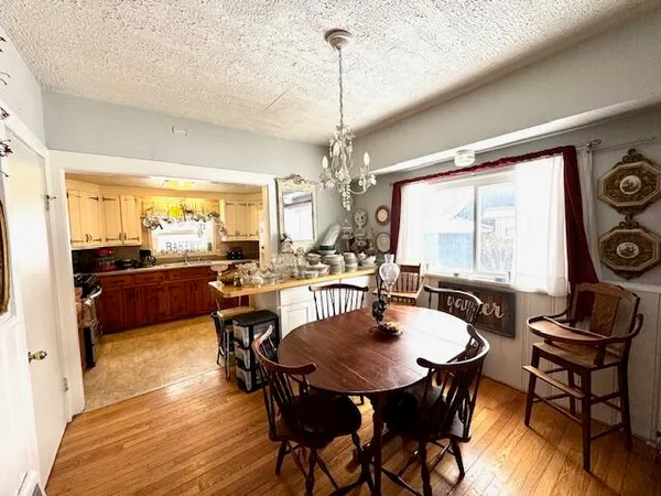 a view of a dining room with furniture and chandelier