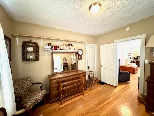 a bedroom with furniture and a wooden floor