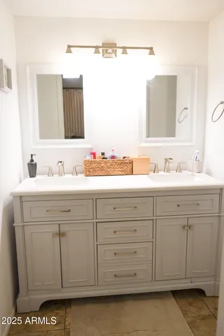 a bathroom with a sink and a mirror