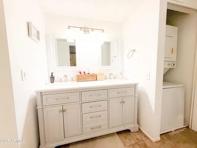 a bedroom with a bed and a painting