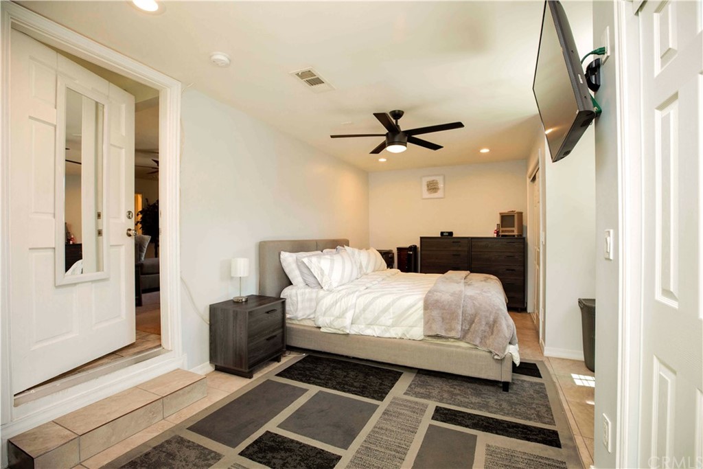 2021 Forest Avenue Pasadena, CA 91103 - Photo 14 of 18 a bedroom with a bed and a chandelier
