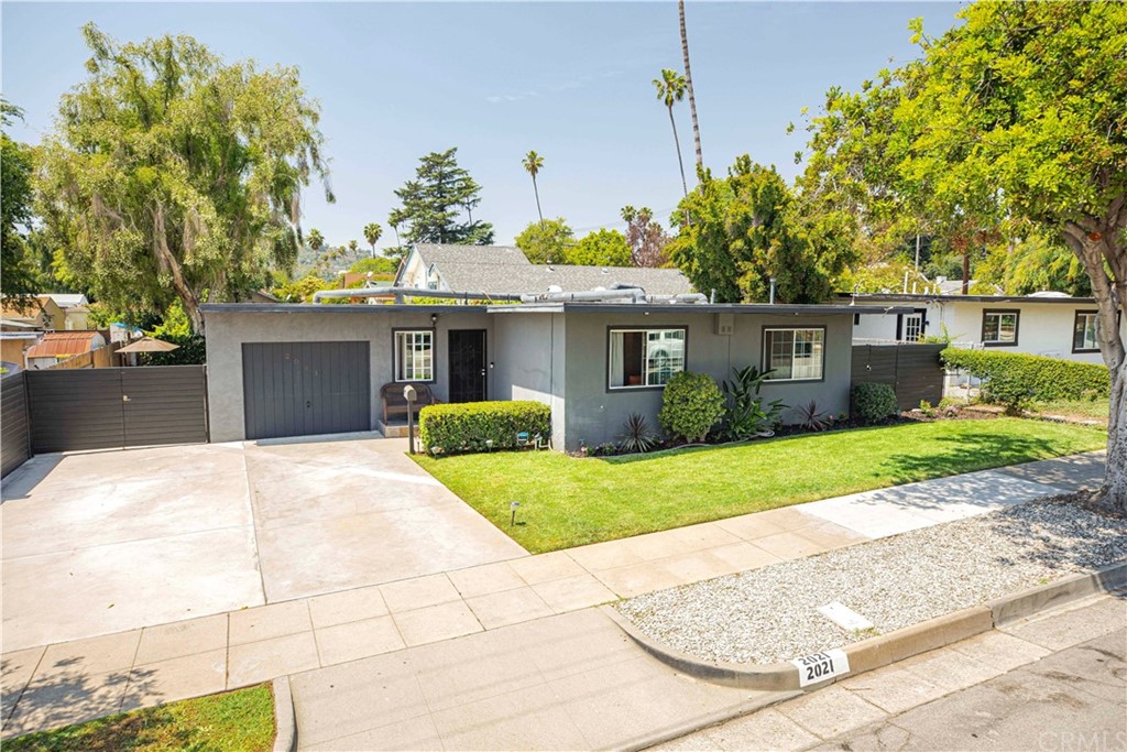 2021 Forest Avenue Pasadena, CA 91103 - Photo 2 of 18 a front view of a house with a yard and garage