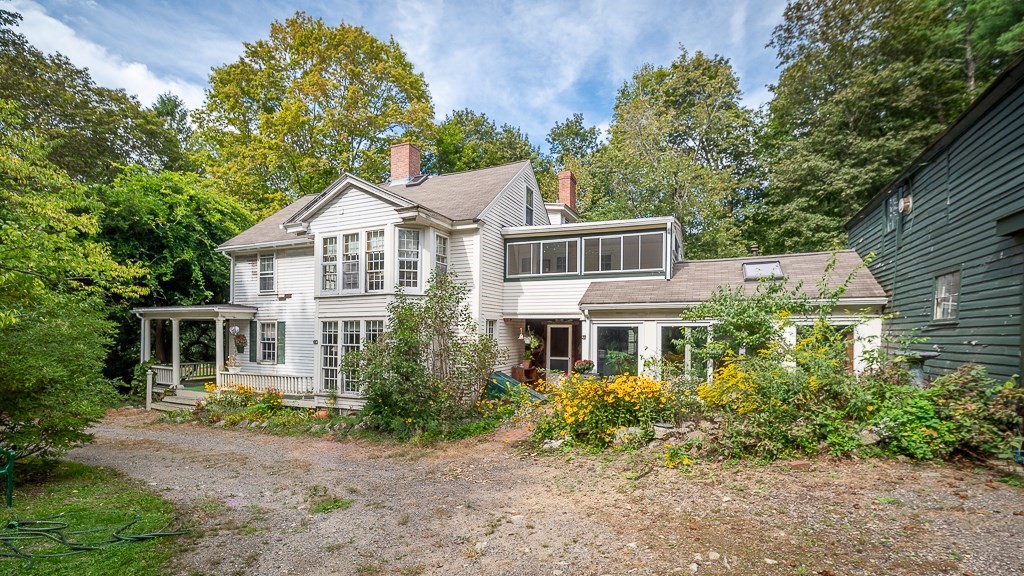 a front view of a house with a garden