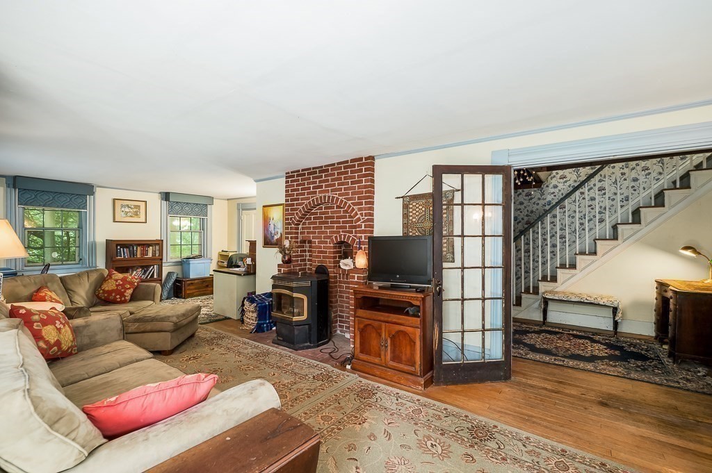 3 Ipswich Road Boxford, MA 01921 - Photo 13 of 37 a living room with furniture a flat screen tv and a fireplace