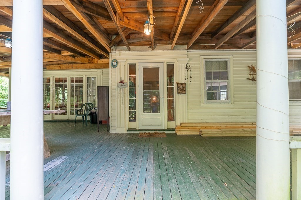 3 Ipswich Road Boxford, MA 01921 - Photo 6 of 37 a view of a porch with wooden floor and floor to ceiling window
