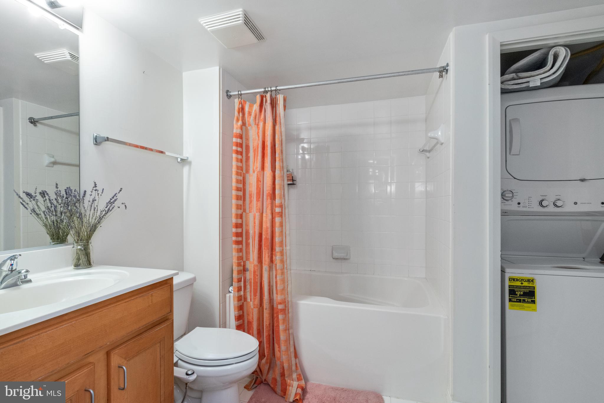 414 Water Street, Unit 2310 Baltimore, MD 21202 - Photo 19 of 31 a bathroom with a granite countertop sink toilet and shower
