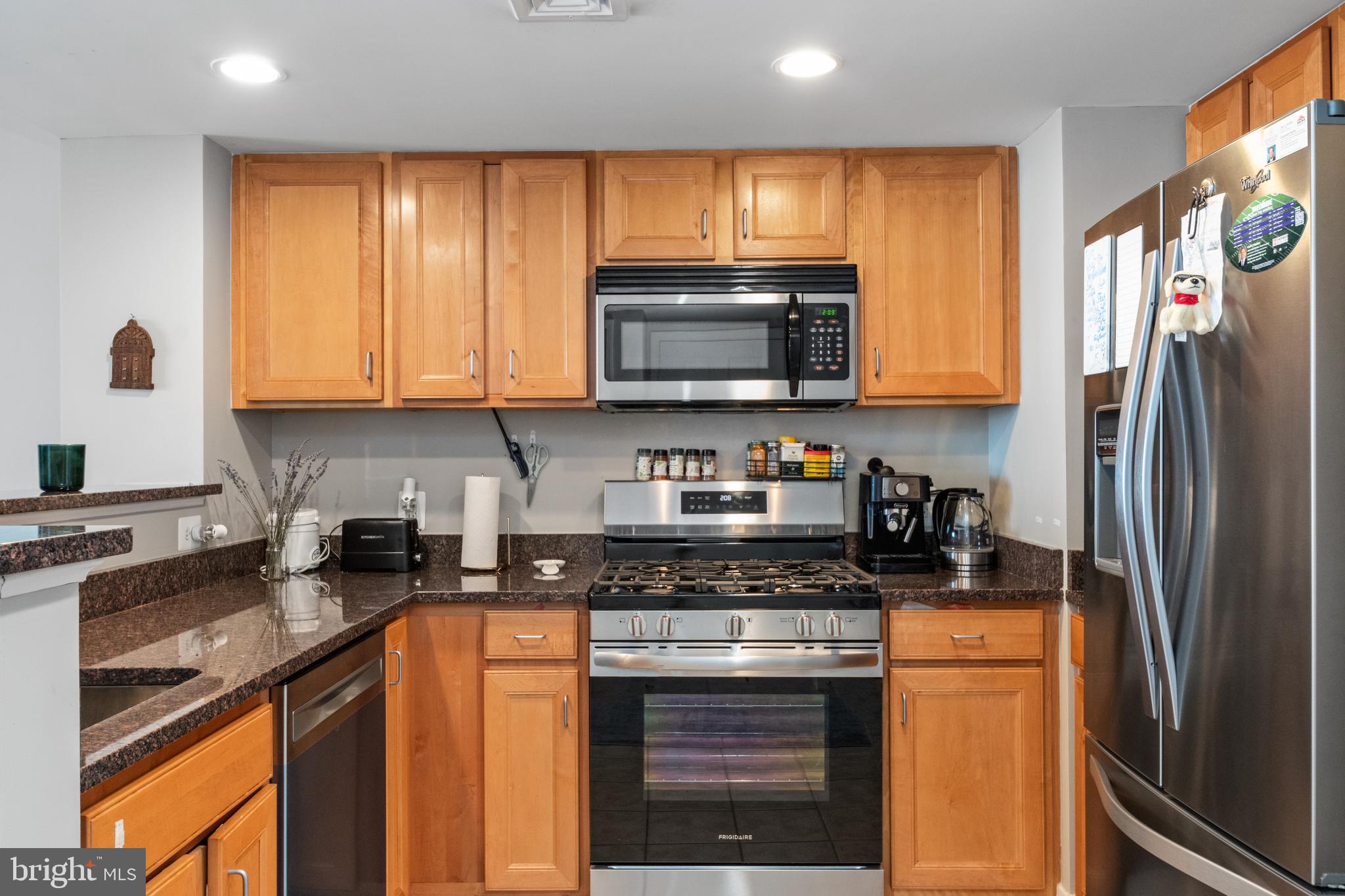 414 Water Street, Unit 2310 Baltimore, MD 21202 - Photo 2 of 31 a kitchen with stainless steel appliances granite countertop a refrigerator stove top oven a sink and dishwasher