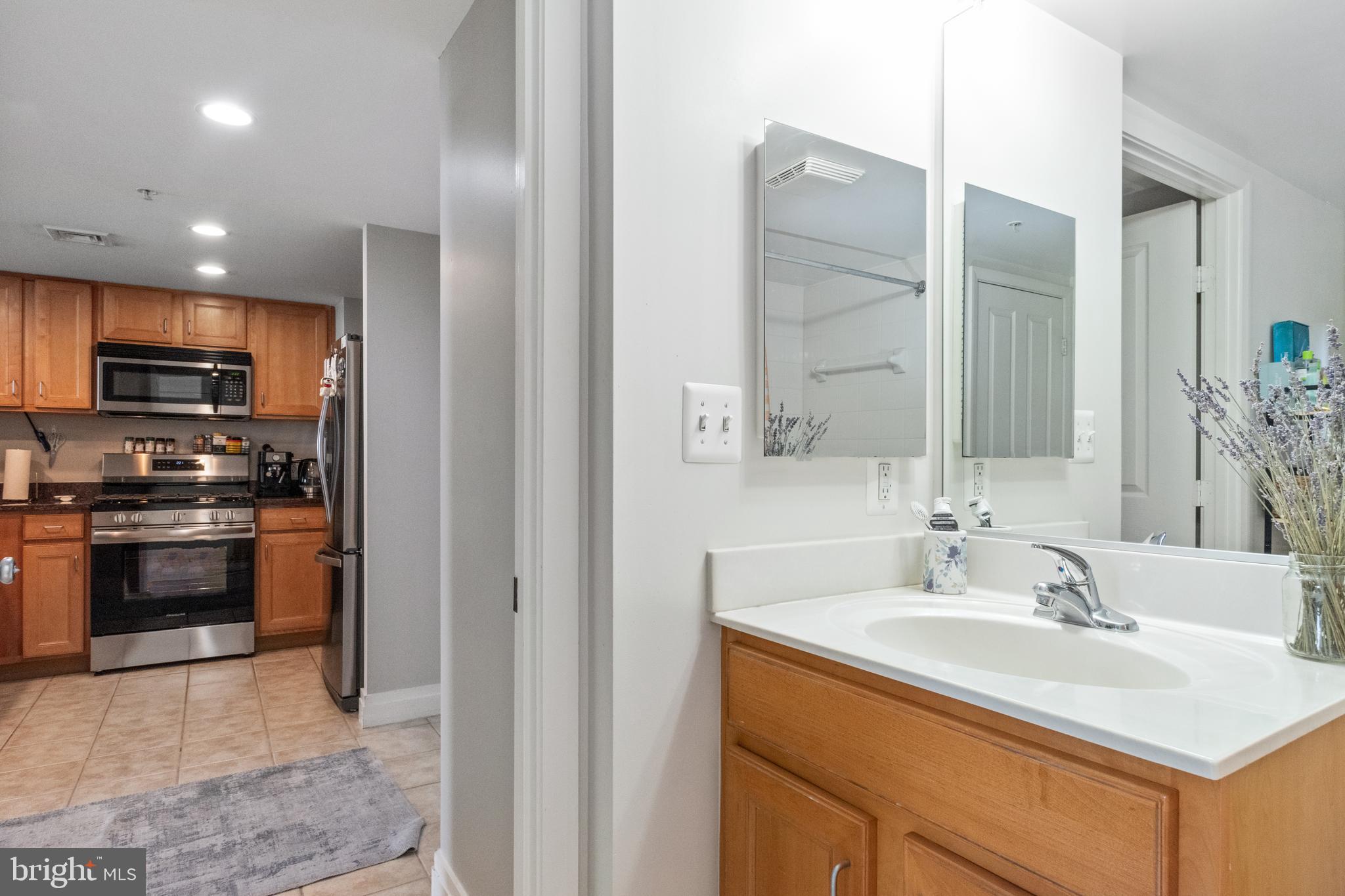 414 Water Street, Unit 2310 Baltimore, MD 21202 - Photo 21 of 31 a kitchen with a sink and a stove top oven