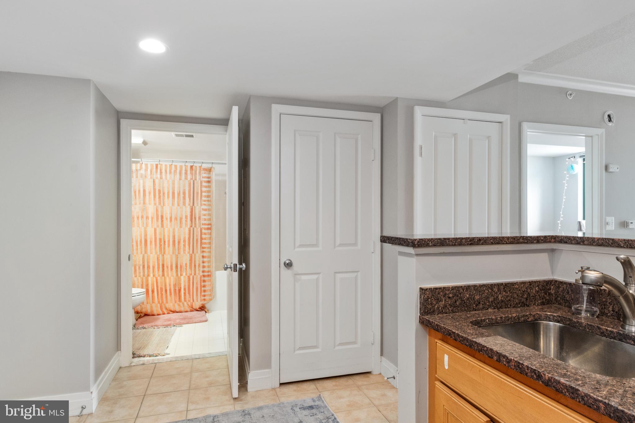 414 Water Street, Unit 2310 Baltimore, MD 21202 - Photo 4 of 31 a kitchen with a sink and a refrigerator