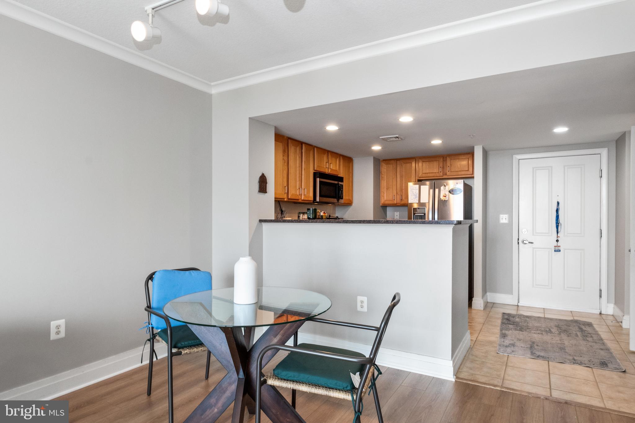 414 Water Street, Unit 2310 Baltimore, MD 21202 - Photo 8 of 31 a view of a dining room with furniture and wooden floor