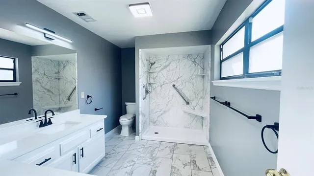 a bathroom with a sink toilet and a mirror