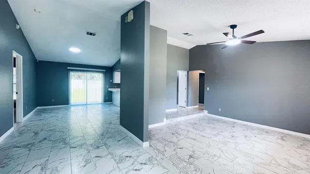 a view of a big room with closet and windows