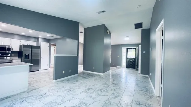 a view of a hallway with living room and couch