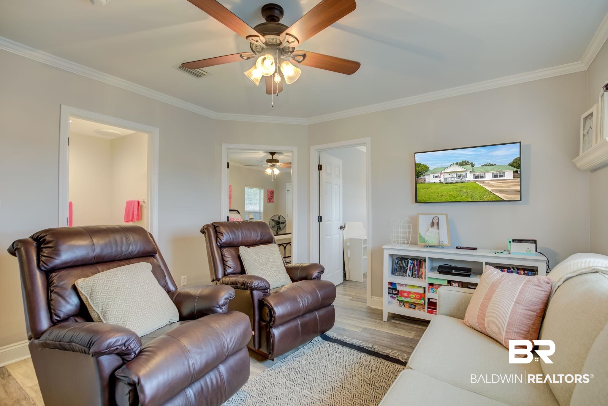18732 Fairground Road Robertsdale, AL 36567 - Photo 18 of 46 Living room featuring ceiling fan, crown molding, and light hardwood / wood-style flooring