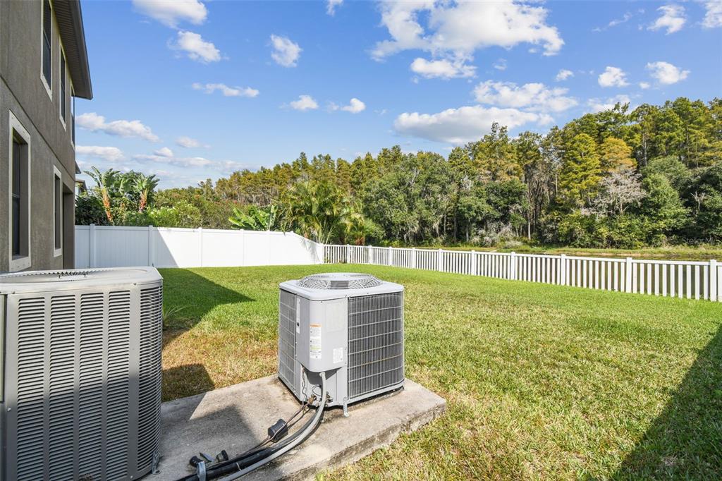 11737 Crestridge Loop New Port Richey, FL 34655 - Photo 13 of 100 a view of a floor to ceiling window and a tree