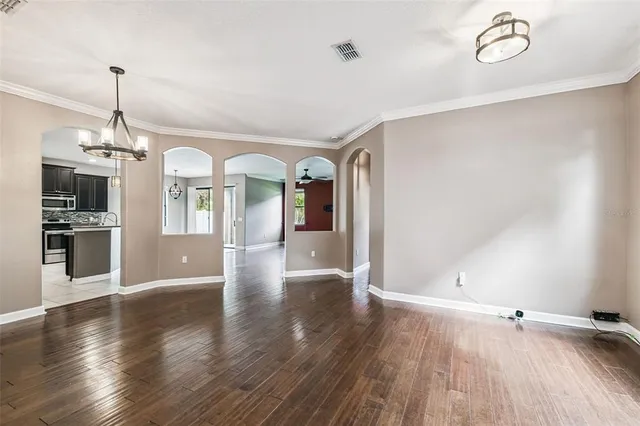 a kitchen with stainless steel appliances granite countertop a sink a stove and a refrigerator