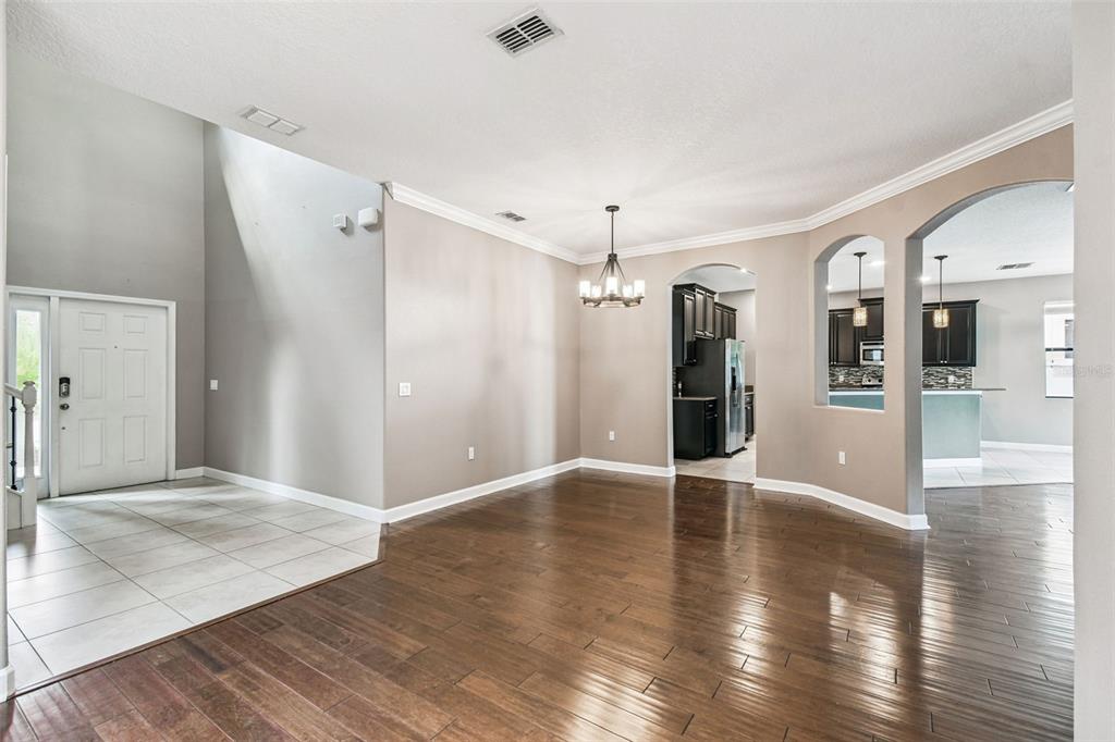 11737 Crestridge Loop New Port Richey, FL 34655 - Photo 16 of 100 a view of an empty room with wooden floor and a large window